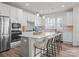 Bright, modern kitchen with white cabinetry, stainless steel appliances, and a stylish center island with seating at 5481 Comiskey Aly, Kannapolis, NC 28081