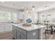 Modern kitchen with white cabinets, stainless appliances, and a large center island perfect for cooking and entertaining at 5481 Comiskey Aly, Kannapolis, NC 28081
