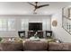 Bright living room featuring comfortable seating, a modern entertainment center, and natural light from shuttered windows at 5481 Comiskey Aly, Kannapolis, NC 28081