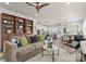 Open-concept living space showcasing a comfortable sofa, stylish decor, and a view into the bright kitchen and dining area at 5481 Comiskey Aly, Kannapolis, NC 28081