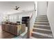 View of the living room, adjacent to a carpeted staircase with white railing leading upstairs at 5481 Comiskey Aly, Kannapolis, NC 28081
