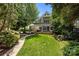 A sprawling green lawn leads up to a covered porch in the backyard at 640 Colville Rd, Charlotte, NC 28207