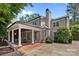 A spacious backyard with a covered patio, stone pavers, and lush landscaping at 640 Colville Rd, Charlotte, NC 28207