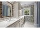Bright bathroom with custom white vanity and a window at 640 Colville Rd, Charlotte, NC 28207