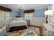 Cozy bedroom with a patterned rug, stylish chandelier, and neutral tones creating a relaxing atmosphere at 640 Colville Rd, Charlotte, NC 28207