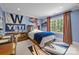 Comfortable bedroom with blue walls and decor, large window with natural light, and wooden furniture at 640 Colville Rd, Charlotte, NC 28207