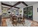 Cozy dining area featuring exposed beams, wood table, and bright natural light at 640 Colville Rd, Charlotte, NC 28207