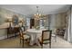 Formal dining room with decorative wallpaper, chandelier, and elegant furnishings at 640 Colville Rd, Charlotte, NC 28207