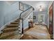 Elegant foyer with a curved staircase, hardwood floors, and stylish decor at 640 Colville Rd, Charlotte, NC 28207