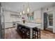 Modern kitchen with stainless steel appliances, white cabinets, and a large center island with seating at 640 Colville Rd, Charlotte, NC 28207