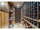 View of the home's charming wooden wine cellar with bottle storage and tile flooring at 640 Colville Rd, Charlotte, NC 28207