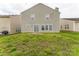 Home with a grassy backyard with a concrete patio at 673 Shellbark Dr, Concord, NC 28025