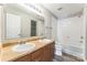 Full bathroom with double sinks, a large mirror, and a shower-tub combination at 673 Shellbark Dr, Concord, NC 28025