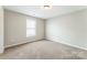Neutral bedroom featuring a window for natural light and plush carpeting at 673 Shellbark Dr, Concord, NC 28025