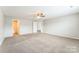 Large bedroom with carpet, a ceiling fan, and ensuite bathroom and closet access at 673 Shellbark Dr, Concord, NC 28025