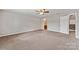 Expansive bedroom with neutral carpet, ceiling fan, and ensuite bathroom access at 673 Shellbark Dr, Concord, NC 28025