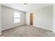 Bright bedroom featuring plush carpeting, a closet, and a window for natural light at 673 Shellbark Dr, Concord, NC 28025