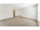 Spacious bedroom featuring neutral paint, plush carpeting, and ample natural light from a large window at 673 Shellbark Dr, Concord, NC 28025