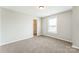 Bright bedroom with plush carpeting, a closet, and a window for natural light at 673 Shellbark Dr, Concord, NC 28025