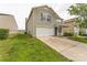 Charming two-story home featuring a well-maintained lawn and a convenient attached two-car garage at 673 Shellbark Dr, Concord, NC 28025