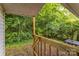 A wood deck overlooks a lush, wooded backyard, perfect for outdoor relaxation at 711 September Ln, Charlotte, NC 28208