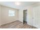 This bright bedroom features modern floors, a window, and a closet for ample storage at 711 September Ln, Charlotte, NC 28208