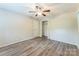 A bedroom features neutral walls, updated vinyl flooring, ceiling fan, and closet at 711 September Ln, Charlotte, NC 28208