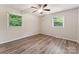 Sunlit bedroom boasting two windows and neutral décor at 711 September Ln, Charlotte, NC 28208