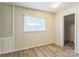 A bedroom features new floors, a window, and modern wall trim at 711 September Ln, Charlotte, NC 28208