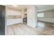 Bright kitchen featuring white cabinets, laminate floors, and neutral paint at 711 September Ln, Charlotte, NC 28208