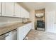 Bright kitchen featuring white cabinets, stainless steel appliances, and updated countertops at 711 September Ln, Charlotte, NC 28208