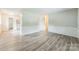 Cozy living room with new laminate flooring and a doorway leading to the kitchen at 711 September Ln, Charlotte, NC 28208