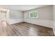 Bright living room with light walls, white trim, and new laminate flooring at 711 September Ln, Charlotte, NC 28208