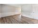 Well-lit living room featuring sleek laminate flooring, fresh paint, and decorative trim at 711 September Ln, Charlotte, NC 28208