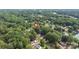 Aerial view of the property surrounded by lush trees, near the calm lake at 7232 Executive Cir, Denver, NC 28037