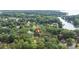 Wide aerial shot of property with red marker showing location among lush trees and the lake at 7232 Executive Cir, Denver, NC 28037