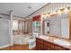 Bathroom featuring double sinks, a soaking tub, and a separate shower, offering a relaxing retreat at 7232 Executive Cir, Denver, NC 28037