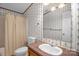 Well-lit bathroom with a vanity, toilet, and shower, providing all the essential amenities at 7232 Executive Cir, Denver, NC 28037