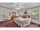 Cozy bedroom featuring a comfortable bed, matching dressers, and three windows for plenty of natural light at 7232 Executive Cir, Denver, NC 28037