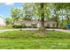 Beautiful home with lush landscaping, gravel driveway, and mature shade trees offering serene setting at 7232 Executive Cir, Denver, NC 28037