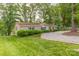 Charming home featuring manicured lawn, gravel driveway, and tasteful landscaping for welcoming curb appeal at 7232 Executive Cir, Denver, NC 28037