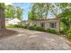 Charming home featuring gravel driveway, manicured bushes, and close proximity to neighboring houses at 7232 Executive Cir, Denver, NC 28037