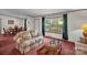 Cozy living room with a sofa, coffee table, and large windows overlooking the outdoors at 7232 Executive Cir, Denver, NC 28037