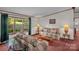Inviting living room features a comfortable sofa and glass end tables with natural lighting at 7232 Executive Cir, Denver, NC 28037