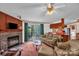 Cozy living room with a stone fireplace, TV, and access to an outdoor patio at 7232 Executive Cir, Denver, NC 28037