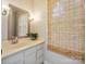 Bright bathroom featuring a vanity with drawers, a decorative mirror, and a window at 7317 Red Branch Ln, Charlotte, NC 28226