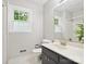 Bathroom featuring a sink vanity, toilet, tiled floor, and a window for natural light at 7317 Red Branch Ln, Charlotte, NC 28226