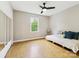 Bright bedroom featuring hardwood floors, a ceiling fan, and neutral walls at 7317 Red Branch Ln, Charlotte, NC 28226
