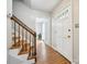 Bright entryway boasts hardwood floors, a staircase with wooden handrail, and natural light, creating a welcoming ambiance at 7317 Red Branch Ln, Charlotte, NC 28226