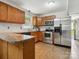 Spacious kitchen features stainless steel appliances, stone countertops and natural wood cabinets at 7317 Red Branch Ln, Charlotte, NC 28226